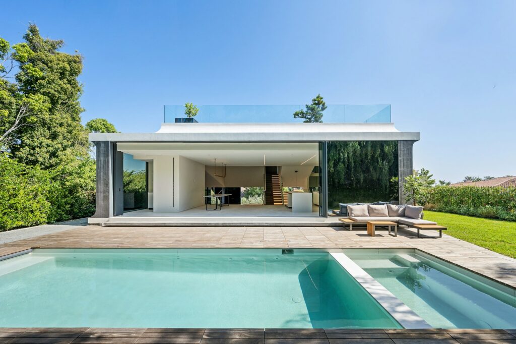 the home is surrounded by greenery and modern architecture, the home is surrounded by greenery and modern architecture,